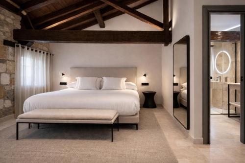 a bedroom with a large bed and a large mirror at Hotel El Paraíso del Pas in Barcenilla