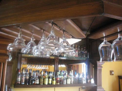 a bar with glasses and bottles on a shelf at Casa Cantarranas in Tehuacán