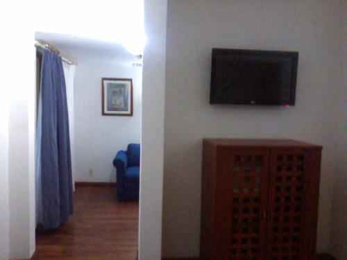 a living room with a flat screen tv on a wall at Casa Cantarranas in Tehuacán