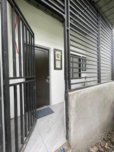 an entrance to a building with a black door at Lavish style at Laguna by Nelson in Biñan