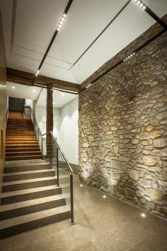 a stone wall and stairs in a building at Casual Gurea in Bilbao