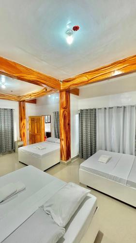 two beds in a room with two bedsvisor at Quartz Suites in Camiguin