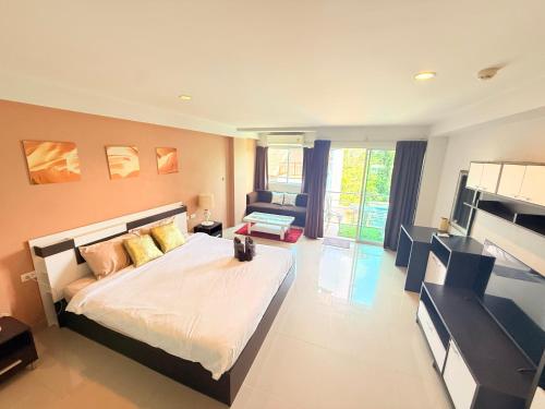 a bedroom with a large bed and a living room at Aonang Mountain View A1 in Ao Nang Beach