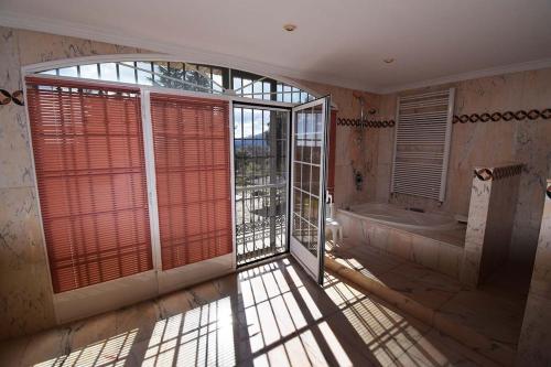 a large bathroom with a tub and a window at Villa la cantera in Guadarrama