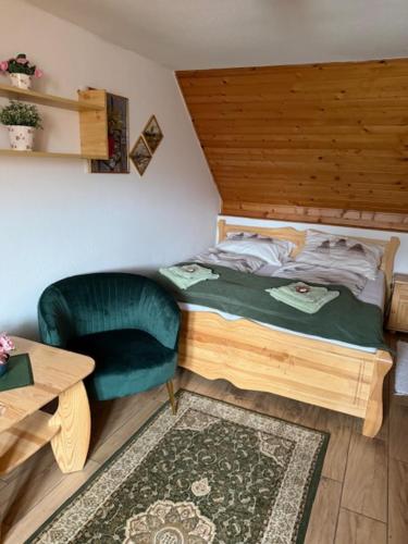 a small bedroom with a bed and a chair at PRIVAT MARIANNA in Žakovce