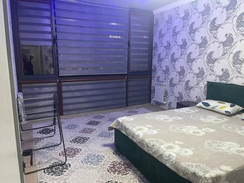 a bedroom with a bed and a purple wall at Seven Resedens 82-15 in Sergeli