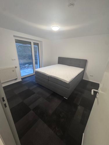 a bedroom with a bed in a room with a window at Ferienapartments Sternen WOHN 6 in Baiersbronn