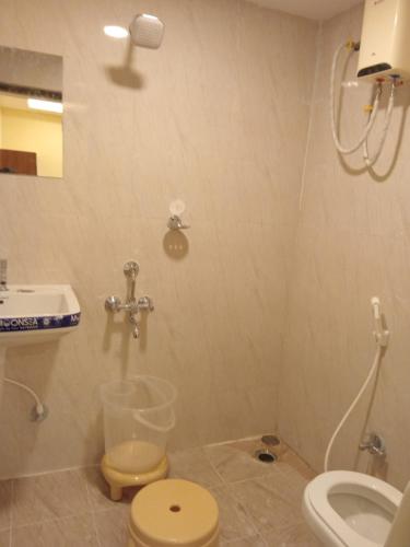 a bathroom with a toilet and a sink at Siddi Vinayaka hotel in Hyderabad