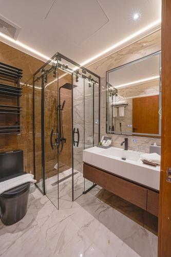 a bathroom with a shower and a sink and a toilet at Grand Iva Hotel Abha in Abha