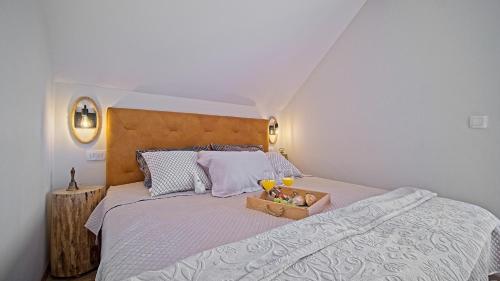 a bedroom with a bed with a box of fruit on it at Villa Debelo Brdo by Villas Guide in Debelo Brdo