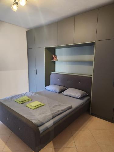 a bedroom with a bed with two towels on it at Luxury Bruchi in Durrës