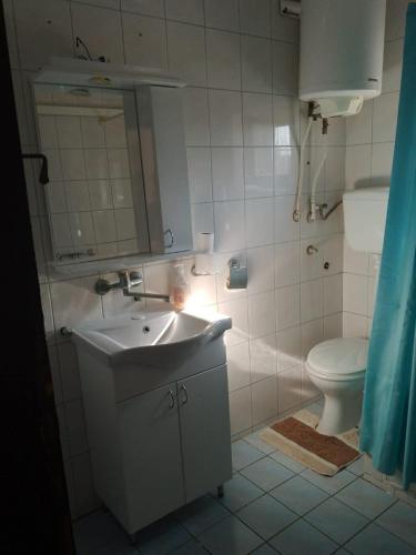 a bathroom with a sink and a toilet at LAVRNIĆ in Apatin