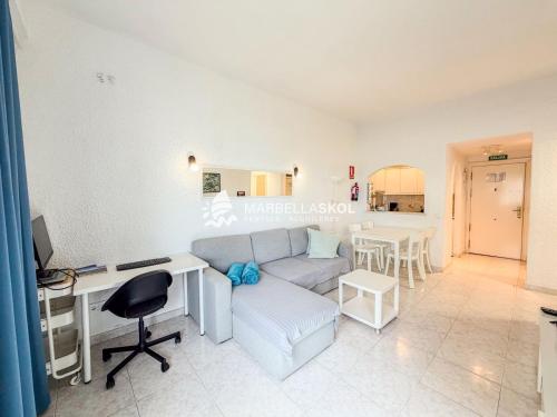 a living room with a couch and a desk at Marbella Skol in Marbella