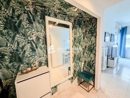 a mirror in a room with a green wall at Marbella Skol in Marbella