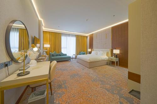 a hotel room with a bed and a mirror at Grand Iva Hotel Abha in Abha