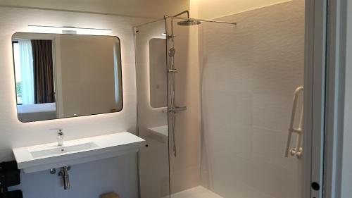 a bathroom with a sink and a mirror and a shower at Casa Rural ASTEI in Muxika