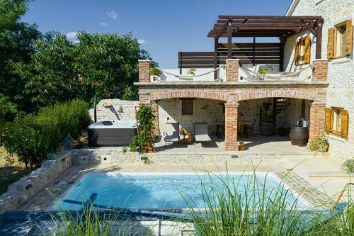 a house with a swimming pool in front of a house at Villa Gland in Nin