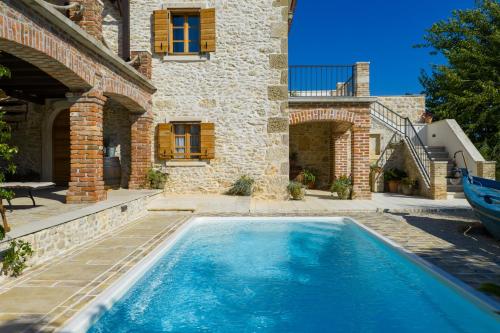 a swimming pool in front of a house at Villa Gland in Nin