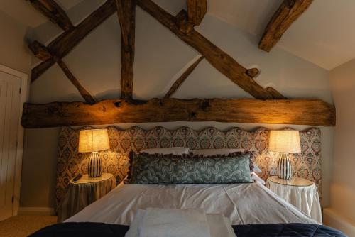 a bedroom with a bed with two lamps at The 3 Acres Inn & Restaurant in Huddersfield