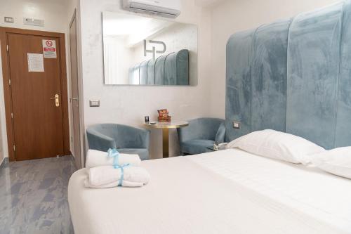 a hotel room with a bed and two chairs at Hotel Paradiso in Lago Patria