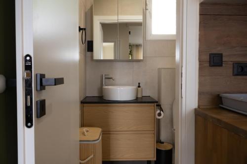 a bathroom with a sink and a mirror at El Koulador House in Ialysos