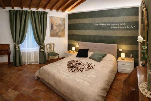 a bedroom with a bed and two tables and a window at La Suite dei Ricordi tra Firenze e Chianti relax arte storia in Impruneta