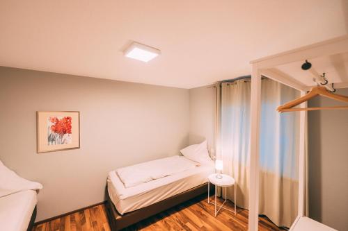a small bedroom with a bed and a window at Haus im Garten in Stockach