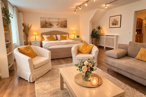 a living room with a bed and a living room with a couch at Rheinpromenade in Kamp-Bornhofen