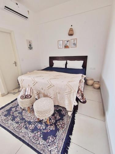 a bedroom with a bed and a rug on the floor at Gypsy Soul Gateaway in Zirakpur