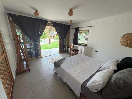 a bedroom with a bed and a desk in it at Casa Ysatis in San Juan