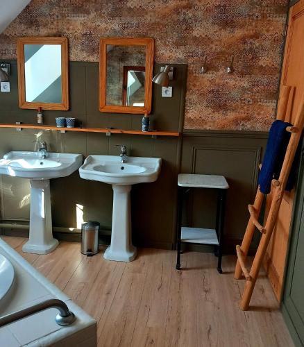 a bathroom with two sinks and a mirror at Laclos des champs in Vadencourt