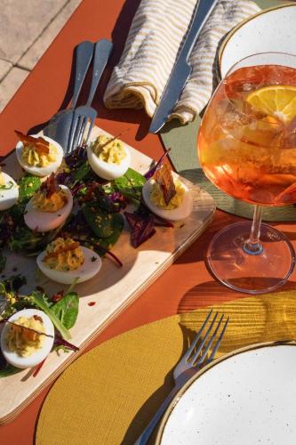 a plate of deviled eggs on a table with a drink at Logis Hostellerie De L'Abbaye in Le Thoronet