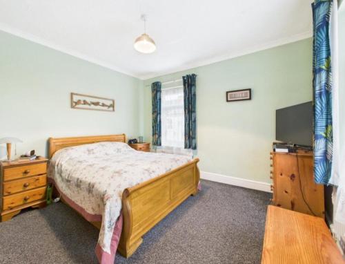 a bedroom with a bed and a flat screen tv at The Bishop Bolthole in Bishop Auckland
