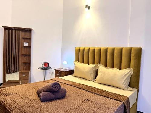 a bedroom with a bed with a towel on it at Home Stay Residence - Near Airport in Negombo
