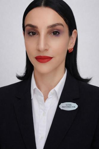 a woman wearing a tuxedo and red lipstick at B&B Domvs tva in Chieti