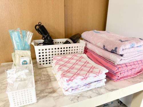 a pile of folded towels sitting on a table at 民泊Toshi29 in Wadomari