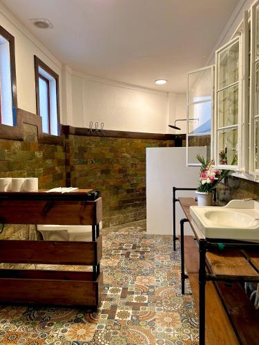 a large bathroom with a sink and a counter at Castle View Hotel Samal in Magamomo