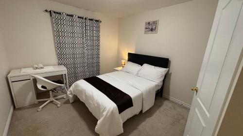 a bedroom with a bed and a desk and a bed sidx sidx sidx at Halton Hills Haven in Milton