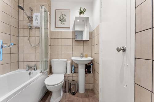 a bathroom with a toilet and a sink and a shower at Private Studio Apartment In Dartford DA1 Free Parking TFL Zone 6 in Slades Green