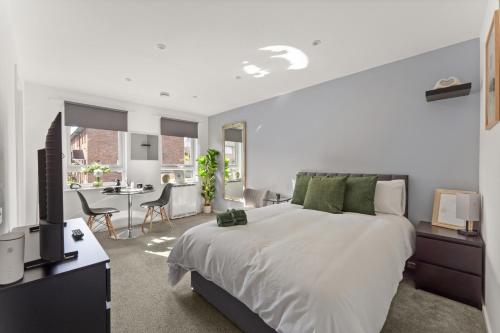 a bedroom with a large bed and a living room at Private Studio Apartment In Dartford DA1 Free Parking TFL Zone 6 in Slades Green