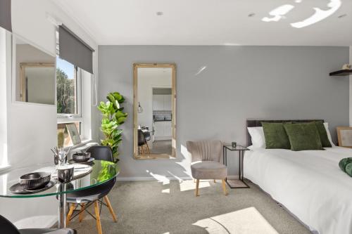 a bedroom with a bed and a table and a mirror at Private Studio Apartment In Dartford DA1 Free Parking TFL Zone 6 in Slades Green