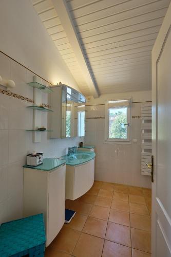 a bathroom with two sinks and a window at Villa 259 in Roquebrune-sur-Argens