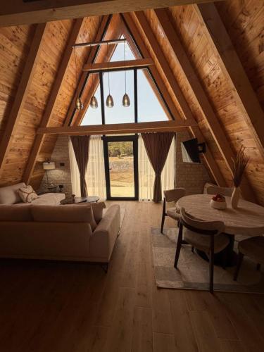 a living room with a couch and a table at Villa Silence in Žabljak