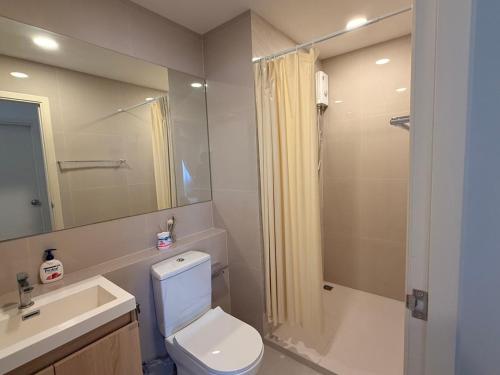 a bathroom with a toilet and a sink and a shower at Xim Condo in Bangkok 20 mins to Asiantique in Ban Tha Hin