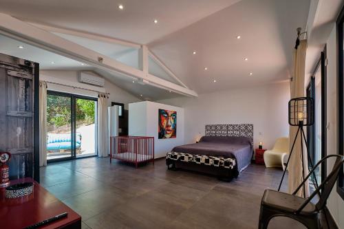 a bedroom with a bed and a large window at Villa 259 in Roquebrune-sur-Argens