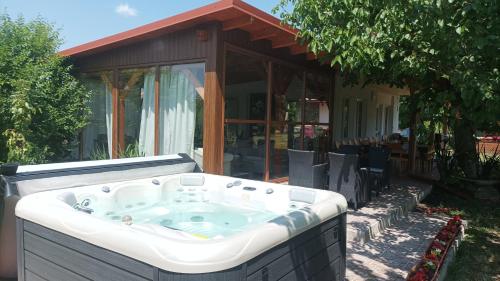 a hot tub in front of a house at Guesthouse Tulipán Vendégház in Kosihy nad Ipľom