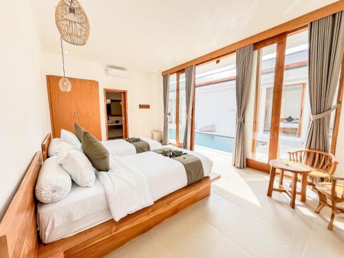 a bedroom with a large bed and a pool at Dolphin - New luxury rooms in Lovina Centre & near the beach in Lovina