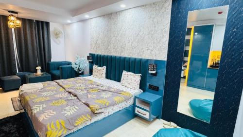 a bedroom with a large bed and a mirror at Elevenstay in Ghaziabad