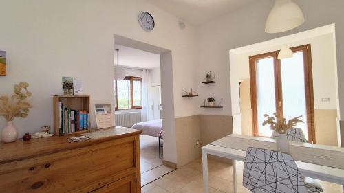 a living room with a desk and a bedroom at Maya Suite & Garden in Sarteano
