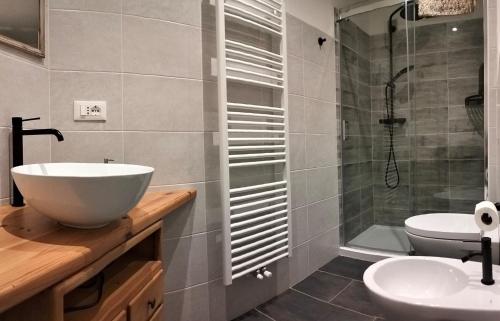 a bathroom with a sink and a shower at Camera con bagno privato in Tesero